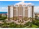 Beautiful condominium exterior, showcasing the coastal style architecture with palm trees and circular driveway at 5823 Bowen Daniel Dr # 906, Tampa, FL 33616