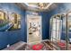 Elegant foyer features blue walls, artwork, a colorful rug, and an ornate mirror at 5823 Bowen Daniel Dr # 906, Tampa, FL 33616
