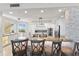 Modern open concept kitchen with stainless steel appliances, a stone accent wall, and a breakfast bar with seating at 5823 Bowen Daniel Dr # 906, Tampa, FL 33616