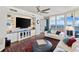 Stylish living room with stone accent wall, built-in shelving, and ocean views at 5823 Bowen Daniel Dr # 906, Tampa, FL 33616