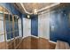 Elegant lobby features dark-blue walls, hardwood floors, an ornate mirror, and elevator access at 5823 Bowen Daniel Dr # 906, Tampa, FL 33616