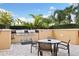 Outdoor kitchen with stainless steel grill, dining table, and privacy landscaping at 5823 Bowen Daniel Dr # 906, Tampa, FL 33616