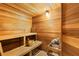 Cozy sauna with wooden benches, a bucket, and a heater for a relaxing experience at 5823 Bowen Daniel Dr # 906, Tampa, FL 33616