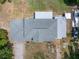 Aerial view of the home's roof, carports, driveway, and surroundings from directly above at 592 Ken Hubbard Rd, Terra Ceia, FL 34250