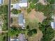 Aerial view of the property lines with a large yard, carport, and mature trees at 592 Ken Hubbard Rd, Terra Ceia, FL 34250