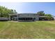 Large backyard with a covered patio, a screened-in porch and a covered car port with a boat at 592 Ken Hubbard Rd, Terra Ceia, FL 34250
