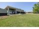 Large backyard with boat storage, expansive lawn, and screened porch at 592 Ken Hubbard Rd, Terra Ceia, FL 34250