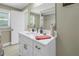Bright bathroom features a single sink vanity, with a large mirror and a shower/tub combination at 592 Ken Hubbard Rd, Terra Ceia, FL 34250