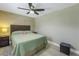 Relaxing bedroom with ceiling fan, unique wallpaper, and neutral color palette at 592 Ken Hubbard Rd, Terra Ceia, FL 34250