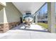 Spacious boat carport featuring a door to the house and ample space for boat storage, accented by brick detailing at 592 Ken Hubbard Rd, Terra Ceia, FL 34250