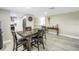 Open dining room area with a large wood table and four chairs between the kitchen and an entryway at 592 Ken Hubbard Rd, Terra Ceia, FL 34250