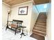 Inviting entryway with elegant bench, accent table, and a staircase leading to the next level at 592 Ken Hubbard Rd, Terra Ceia, FL 34250