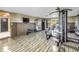 Home gym features exercise machines, wood-look floors, TV and access to the outside patio at 592 Ken Hubbard Rd, Terra Ceia, FL 34250