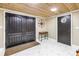 Elegant foyer featuring double doors, wood plank ceiling, marble flooring, and a charming decorative compass on the wall at 592 Ken Hubbard Rd, Terra Ceia, FL 34250