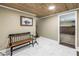 Hallway features marble flooring, wood plank ceiling, a bench and access to the home gym at 592 Ken Hubbard Rd, Terra Ceia, FL 34250