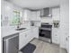 Beautiful kitchen featuring all white cabinets and stainless steel appliances at 592 Ken Hubbard Rd, Terra Ceia, FL 34250
