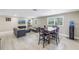 Bright living room and dining area featuring contemporary furnishings and natural light at 592 Ken Hubbard Rd, Terra Ceia, FL 34250