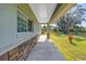 Covered walkway showing a walkway leading to a home with brick accents and a view of the lawn at 592 Ken Hubbard Rd, Terra Ceia, FL 34250