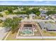 Aerial view of home showcasing its position in the neighborhood, fenced yard, and pool at 6507 61St E Dr, Palmetto, FL 34221
