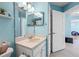 Bright bathroom featuring a vanity with ample counter space and views into the adjacent bedroom at 6507 61St E Dr, Palmetto, FL 34221