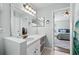 Bright bathroom featuring a vanity with ample counter space and views into the bedroom at 6507 61St E Dr, Palmetto, FL 34221