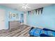 Bright bedroom showcasing stylish floors, fresh blue paint, and charming decor at 6507 61St E Dr, Palmetto, FL 34221