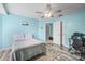 Bedroom featuring stylish floors, fresh blue paint, and a computer desk setup at 6507 61St E Dr, Palmetto, FL 34221