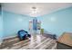 Blue-walled bedroom featuring modern floors, a ceiling fan, and a window for natural light at 6507 61St E Dr, Palmetto, FL 34221