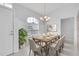 Bright dining room with modern chandelier, shiplap walls and an open layout to living area at 6507 61St E Dr, Palmetto, FL 34221