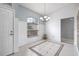 Bright dining room with modern chandelier, shiplap walls and an open layout to living area at 6507 61St E Dr, Palmetto, FL 34221