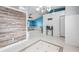 Welcoming foyer featuring decorative tile, shiplap accent walls and an open layout to living area at 6507 61St E Dr, Palmetto, FL 34221