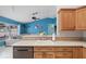 Cozy kitchen area with tile backsplash and view into an adjacent living space at 6507 61St E Dr, Palmetto, FL 34221