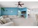 Cozy living room featuring a ceiling fan, and an entertainment center and plush seating at 6507 61St E Dr, Palmetto, FL 34221