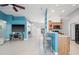 Cozy living room featuring a ceiling fan and breakfast bar seating for a modern appeal at 6507 61St E Dr, Palmetto, FL 34221
