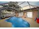 Beautiful kidney-shaped screened-in pool with ample deck space for entertaining and relaxing at 6507 61St E Dr, Palmetto, FL 34221