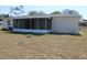 Exterior rear view of house showing a covered, screened-in patio at 7319 Holiday Dr, Spring Hill, FL 34606