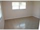 Bedroom with tiled floor and a window that brings in natural light at 7319 Holiday Dr, Spring Hill, FL 34606