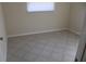 Neutral-colored bedroom with tiled floor and a window that brings in natural light at 7319 Holiday Dr, Spring Hill, FL 34606
