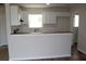 Bright, open kitchen featuring modern white cabinetry and a breakfast bar at 7319 Holiday Dr, Spring Hill, FL 34606