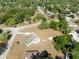 Aerial view of a home with a large yard and driveway with trees at 7346 Hiawatha Pkwy, Spring Hill, FL 34606