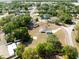 Aerial view showcasing a home with property outlined in red, surrounded by lush trees at 7346 Hiawatha Pkwy, Spring Hill, FL 34606