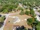 Aerial view showcases the property outlined in red with mature trees surrounding the home at 7346 Hiawatha Pkwy, Spring Hill, FL 34606