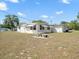 The charming home is surrounded by beautiful green lawns and trees at 7346 Hiawatha Pkwy, Spring Hill, FL 34606