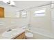Bright bathroom with white tile, tub, shower, and updated vanity at 7346 Hiawatha Pkwy, Spring Hill, FL 34606
