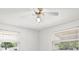 Bedroom with white walls and ceiling, and two windows and ceiling fan at 7346 Hiawatha Pkwy, Spring Hill, FL 34606