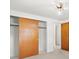 Bedroom boasts neutral walls, carpet, and large closet with wood sliding doors at 7346 Hiawatha Pkwy, Spring Hill, FL 34606