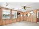 Bonus room with wood paneling, offering views and access to the outdoors at 7346 Hiawatha Pkwy, Spring Hill, FL 34606