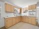 Classic eat-in kitchen features blond wood cabinets, laminate countertops, and white appliances at 7346 Hiawatha Pkwy, Spring Hill, FL 34606
