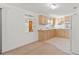 This open kitchen offers blonde wood cabinets and a peek into the adjacent bathroom at 7346 Hiawatha Pkwy, Spring Hill, FL 34606