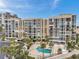 Aerial view of the condominium complex and surrounding community, featuring a large pool at 7400 Sun Island S Dr # 206, South Pasadena, FL 33707